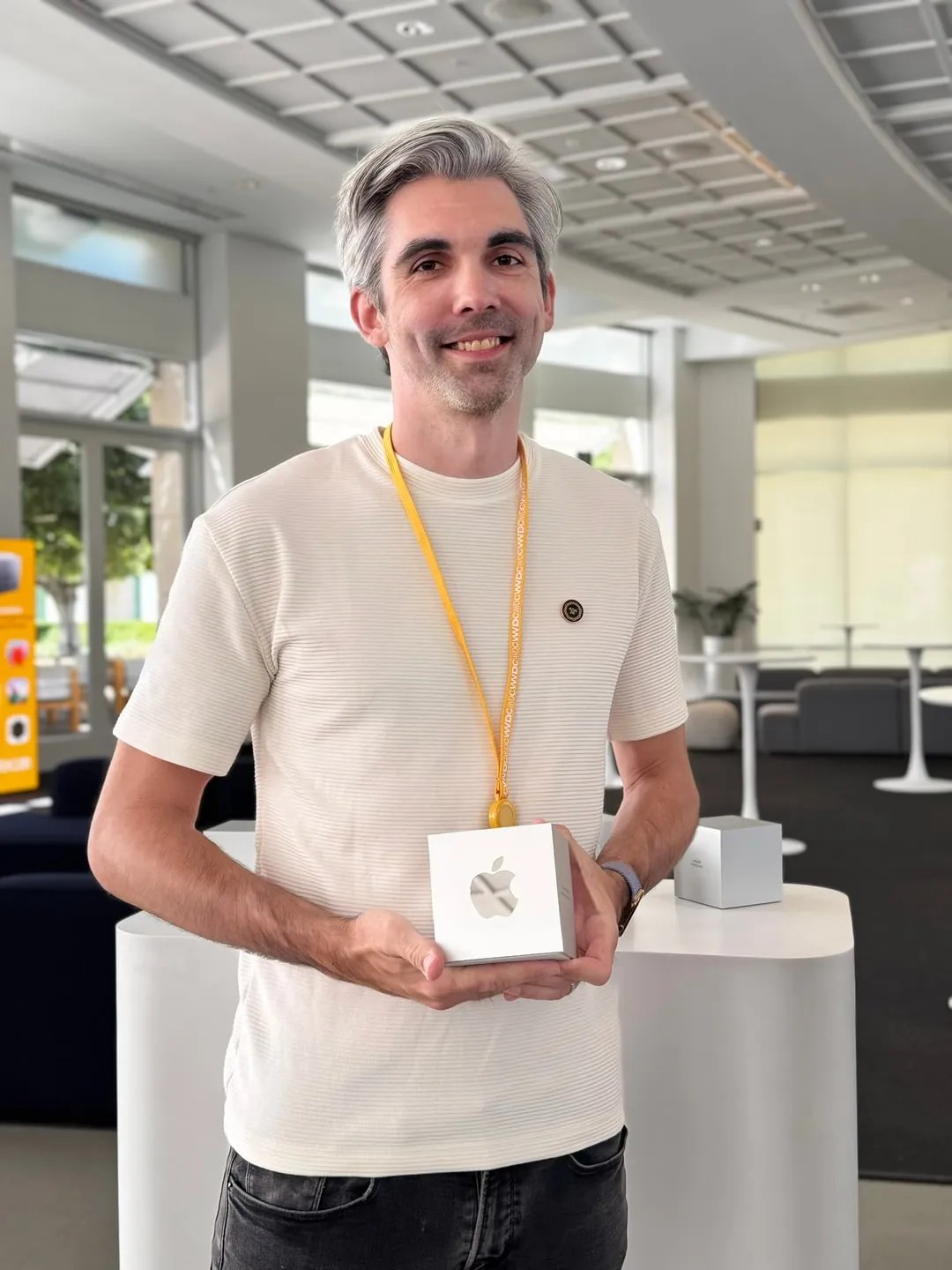 Matthew Parrott holding an Apple Design Award trophy, a small white cube with the Apple logo.
